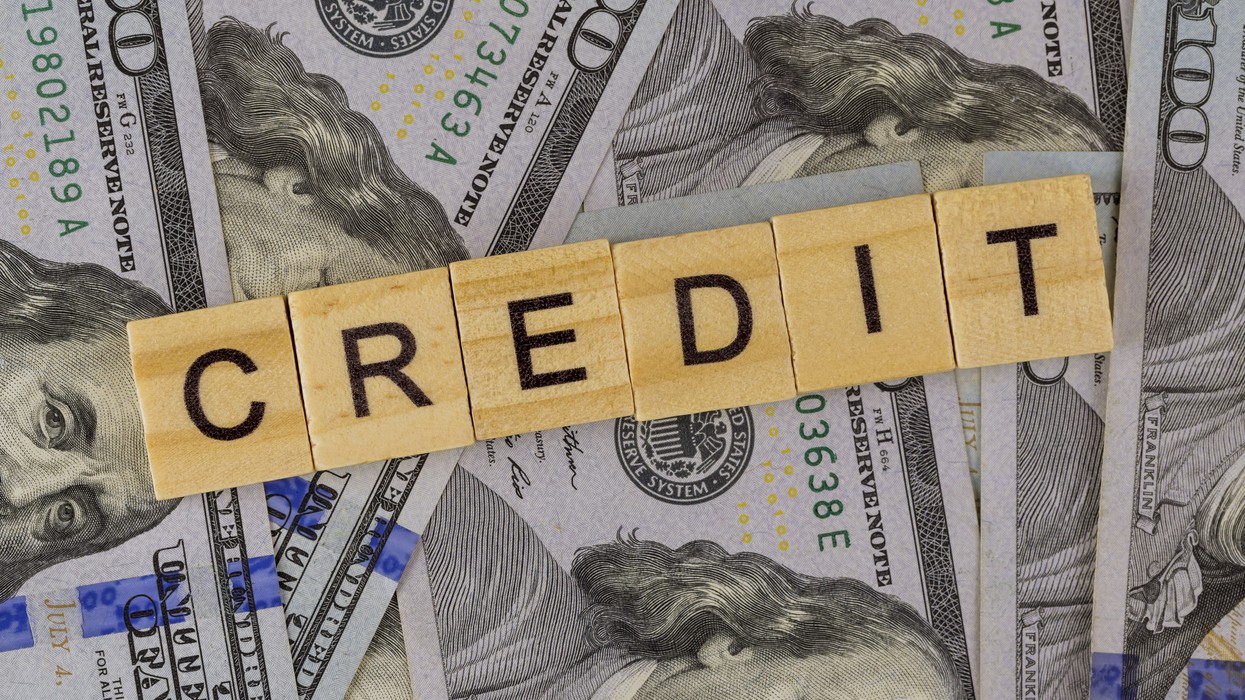  Credit word made by wood blocks and dollars money